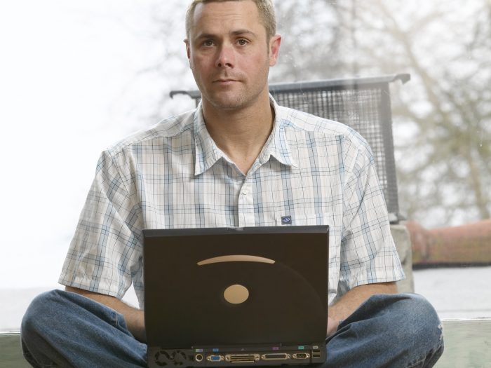 Serious man with laptop computer