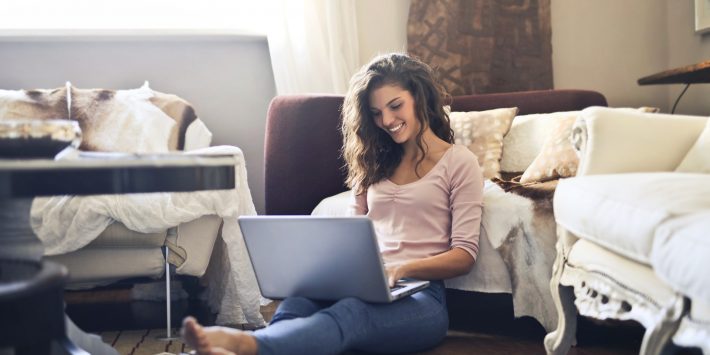 woman-smiling-while-using-laptop-3769717