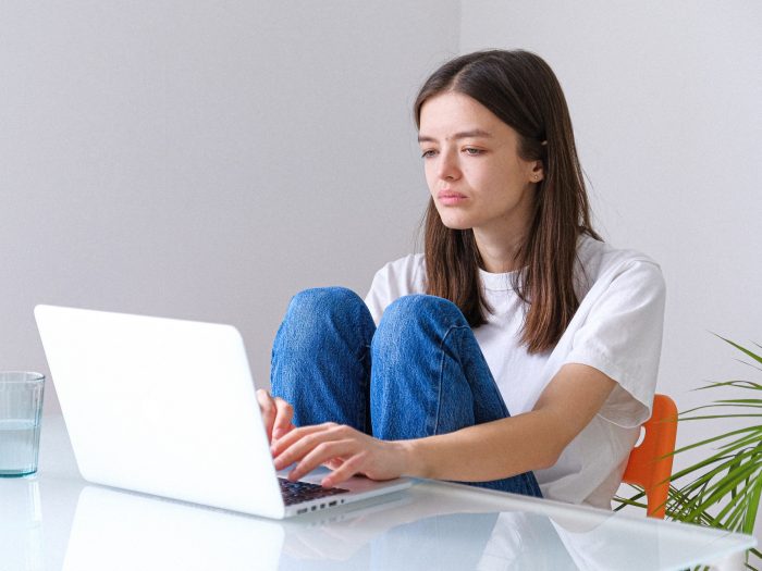woman-in-white-t-shirt-and-blue-denim-jeans-working-on-a-3987031