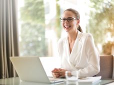 laughing-businesswoman-working-in-office-with-laptop-3756679