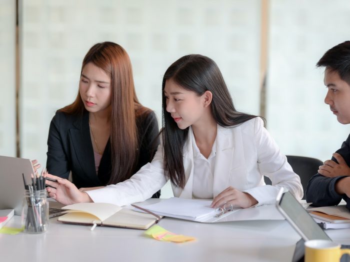woman-in-white-blazer-sitting-beside-woman-in-black-blazer-3843354