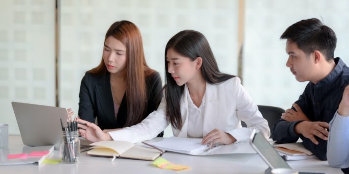 woman-in-white-blazer-sitting-beside-woman-in-black-blazer-3843354